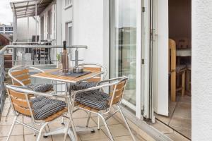 a table and chairs sitting on a balcony at Schwarzwaldblick in Sankt Georgen im Schwarzwald