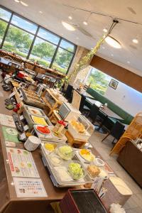 a buffet line with many plates of food at Nobeoka Urban Hotel in Nobeoka