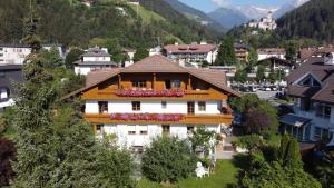 a house with flower boxes on the roof in a village at App Sonnenschein - Duregger in Campo Tures