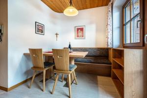 a dining room with a table and two chairs at App Sonnenschein - Duregger in Campo Tures