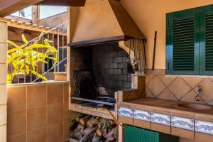 a outdoor kitchen with a pizza oven in a house at Finca Es Turo in Santanyi +19 photos