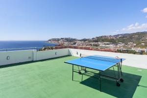 a ping pong table on the roof of a house at Villa Joya del Mediterraneo in Almuñécar