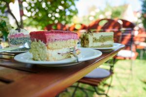 three pieces of cake on plates on a wooden table at Winzercafé Neipperg in Brackenheim +89 photos