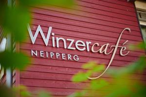 a sign on the side of a red building at Winzercafé Neipperg in Brackenheim