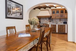 a kitchen and dining room with a wooden table and chairs at Casa Cennano in Montevarchi +33 photos