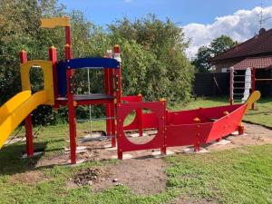 a playground with a slide in a yard at Haus Seestern in Walchum