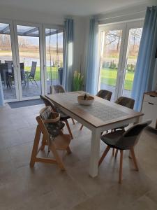 a table and chairs in a room with a dining room at Haus Seestern in Walchum