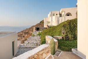 a stairway leading up to a white building at Paros - Sikinos Sunset in Sikinos