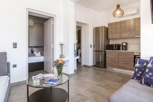 a living room with a coffee table and a kitchen at Sunset Horizon Villa in Mikonos +9 photos