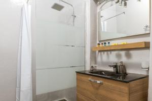 a bathroom with a sink and a mirror at Sunset Horizon Villa in Mikonos