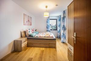 a small bedroom with a bed with a wooden floor at Erkheim in Erkheim