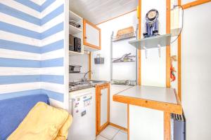 a tiny kitchen with a counter and a sink at Chalet B Village Vacances in Gujan-Mestras +25 photos