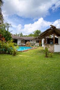 a house with a swimming pool in a yard at Chez L'Avocatier in Sainte Marie