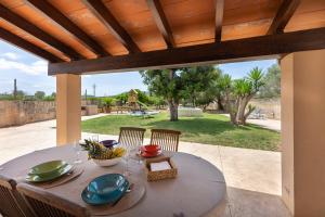 a table with a bowl of fruit on a patio at Es Cos in Algaida