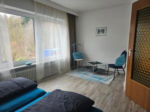 a bedroom with a bed and a table and a window at Haus am Goldberg in Tannheim