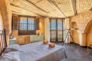 a bedroom with a bed and a camera at Casa Rural Ermita de las eras in Algarinejo +27 photos