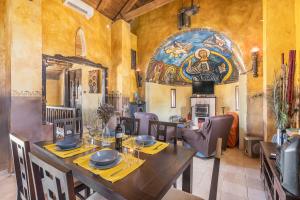a dining room with a wooden table and chairs at Casa Rural Ermita de las eras in Algarinejo