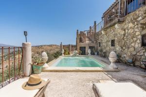 a house with a swimming pool in a yard at Casa Rural Ermita de las eras in Algarinejo