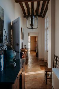 a living room with a table and a chandelier at La Maison de Melmont in Roumare