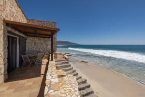 a house with a table and chairs on the beach at Casa Nostra in Pájara