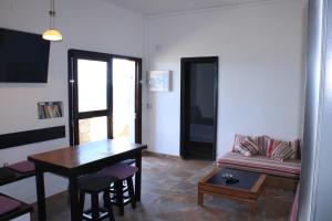 a living room with a table and a couch at Casa Nostra in Pájara +19 photos
