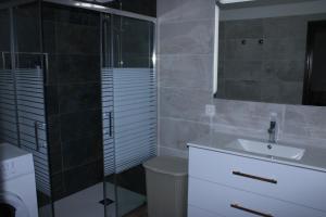 a bathroom with a shower and a sink and a mirror at Casa Nostra in Pájara