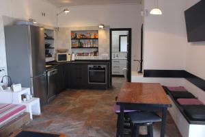 a kitchen with a wooden table and a counter top at Casa Nostra in Pájara
