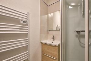 a bathroom with a sink and a mirror at Prapoutel pied des pistes in Les Adrets +12 photos