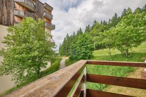a bridge over a river next to a building at Prapoutel pied des pistes in Les Adrets