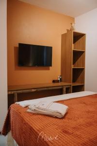 a bedroom with a bed with a flat screen tv on the wall at Apartamento Verano pé na areia em tatuamunha - NSUN105 in Pôrto de Pedras +33 photos