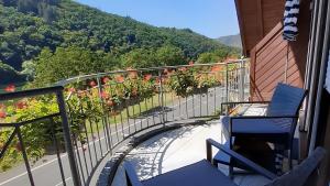 a balcony with chairs and a view of a mountain at Haus Moselliebe charmant zimmer in Ediger-Eller +5 photos