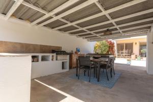 a kitchen and dining room with a table and chairs at Pomme Reinette in Le Val