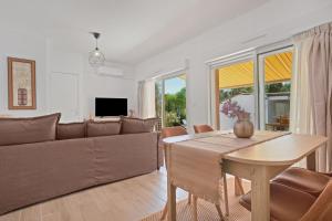 a living room with a couch and a table at Pomme Reinette in Le Val