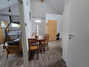 a room with a table and chairs and a bunk bed at La petite ferme de Fine in Burg bei Magdeburg