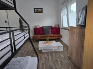 a living room with a couch and a table at La petite ferme de Fine in Burg bei Magdeburg