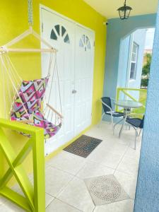 a room with a hammock and a table and chairs at Cool Stay in Christ Church