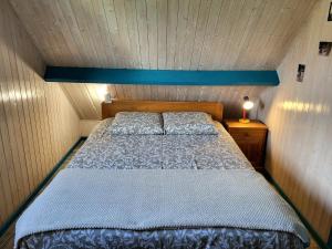 a bedroom with a bed in a small room at Maison De Bord De Mer in Pirou