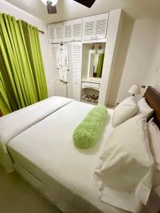 a bedroom with a bed with a green rug on it at Cool Stay in Christ Church