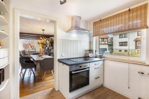 a kitchen with a stove top oven next to a dining room at You R Welcome too in Frischborn