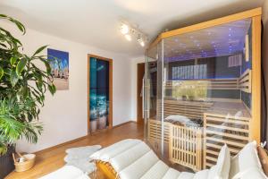 a living room with a white couch and a large window at You R Welcome too in Frischborn