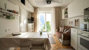 a kitchen and living room with a table and a couch at Ferienwohnung Lichtblick in Sattendorf