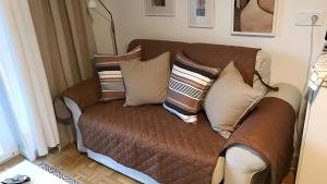a brown couch with pillows on it in a room at Ferienwohnung Lichtblick in Sattendorf