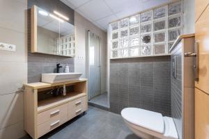 a bathroom with a toilet and a sink and a shower at Casa Thaiker in Miami Platja +32 photos