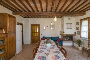a living room with a table and a couch at Stupendo rustico in pietra in Castellina Marittima