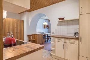 a kitchen with a red kettle on a counter at Sabina Dolomites Santner in Alpe di Siusi