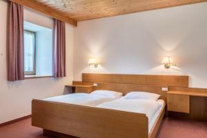 a bedroom with two beds and a window at Sabina Dolomites Santner in Alpe di Siusi +20 photos