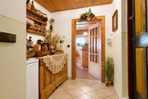 a kitchen with a door leading into a kitchen with people in it at Veltierhof Villnöß in Funes