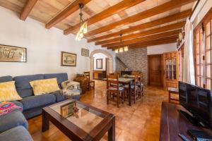 a living room with a blue couch and a table at Villa La Plana in Pollença