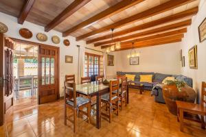 a living room with a table and a couch at Villa La Plana in Pollença