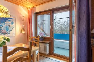 a room with a dining table and a window at Ferienwohnung Schlegel in Singen